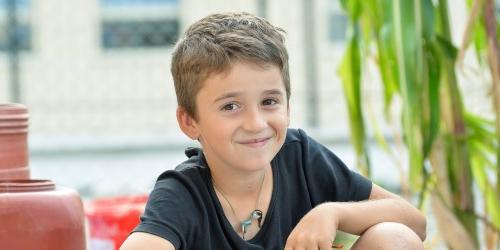 Boy sitting and smiling